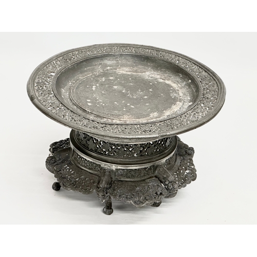 194 - A 19th century Burmese pierced Pewter stand, raised on 6 feet. Circa 1820-1860. 23x14cm