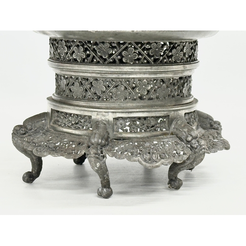 194 - A 19th century Burmese pierced Pewter stand, raised on 6 feet. Circa 1820-1860. 23x14cm