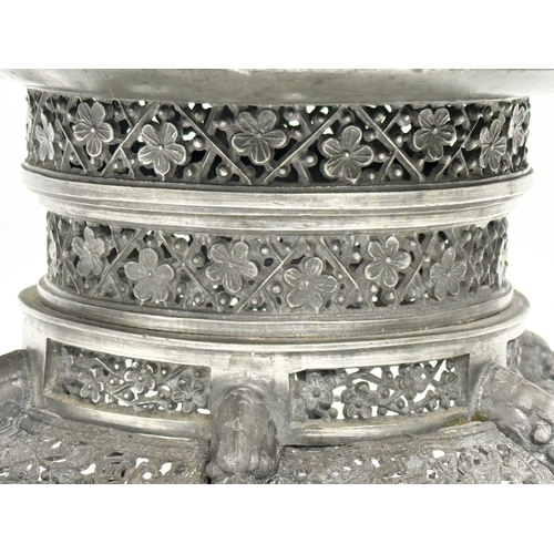 194 - A 19th century Burmese pierced Pewter stand, raised on 6 feet. Circa 1820-1860. 23x14cm