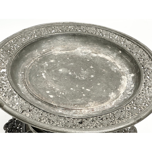 194 - A 19th century Burmese pierced Pewter stand, raised on 6 feet. Circa 1820-1860. 23x14cm