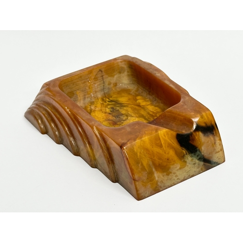 54 - An Art Deco Butterscotch Phenolic Bakelite ashtray by Carvacraft. A Dickenson Product. 8x10cm