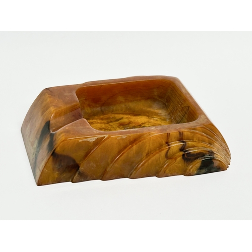 54 - An Art Deco Butterscotch Phenolic Bakelite ashtray by Carvacraft. A Dickenson Product. 8x10cm