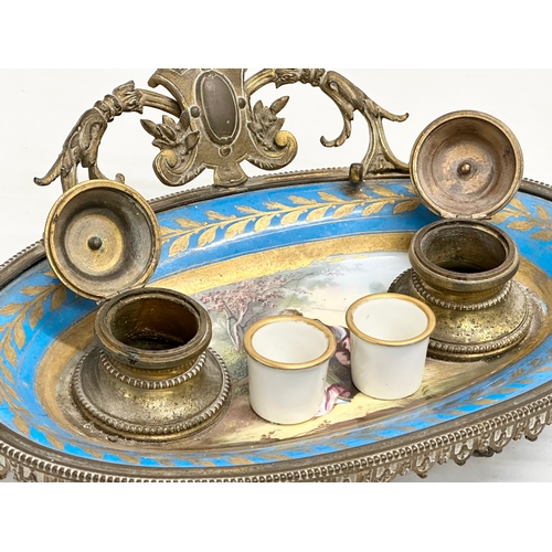 55 - A late 19th century French ornate brass framed inkwell stand with hand painted porcelain bowl. Sevre... 