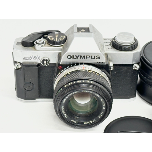 543 - A vintage Olympus OM20 camera and a Canon lens with case.