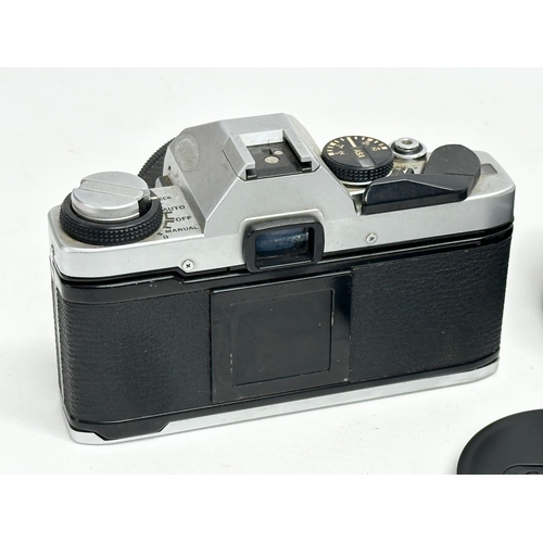 543 - A vintage Olympus OM20 camera and a Canon lens with case.