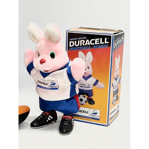 546 - Duracell. A Duracell Kayaking Bunny with box and a Duracell Football Bunny with box. 35cm