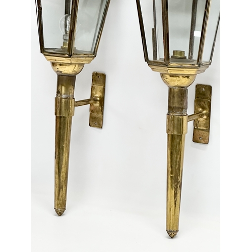 129 - A pair of large early 20th century brass wall lanterns. Circa 1900. 77cm