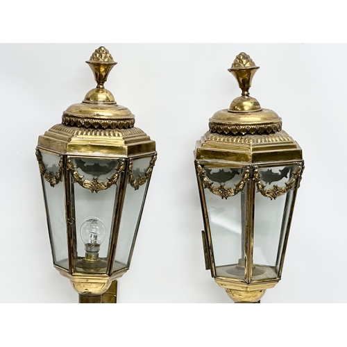 129 - A pair of large early 20th century brass wall lanterns. Circa 1900. 77cm