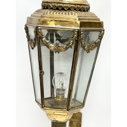 129 - A pair of large early 20th century brass wall lanterns. Circa 1900. 77cm