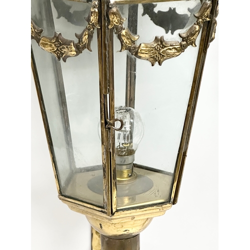 129 - A pair of large early 20th century brass wall lanterns. Circa 1900. 77cm