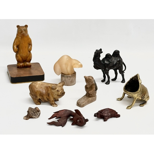 720 - A collection of 20th century stone and wooden animals.