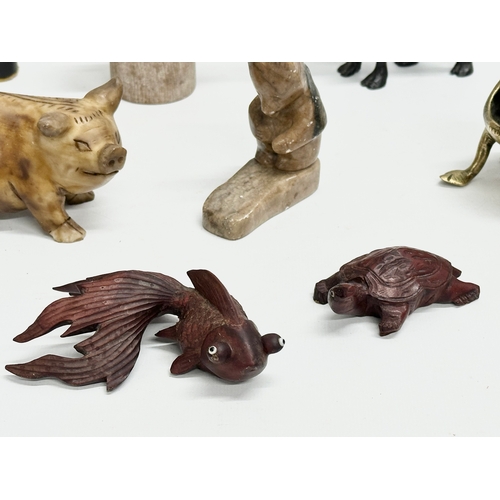 720 - A collection of 20th century stone and wooden animals.