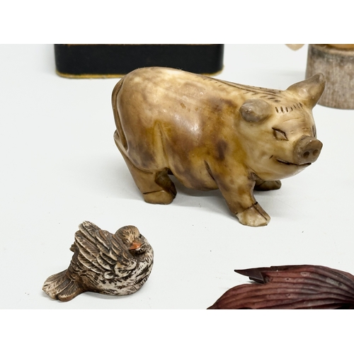 720 - A collection of 20th century stone and wooden animals.