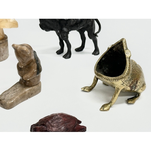 720 - A collection of 20th century stone and wooden animals.