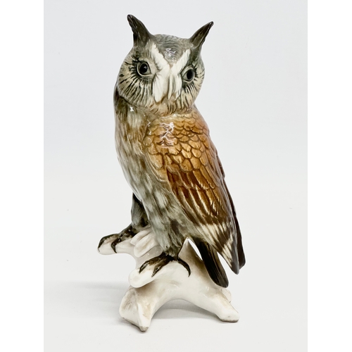 721 - A mid 20th century Karl Ens pottery owl on branch. 17cm.