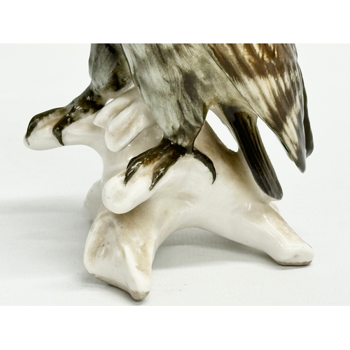 721 - A mid 20th century Karl Ens pottery owl on branch. 17cm.