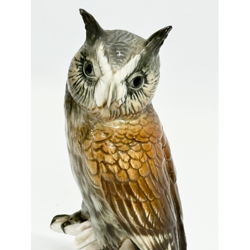 721 - A mid 20th century Karl Ens pottery owl on branch. 17cm.