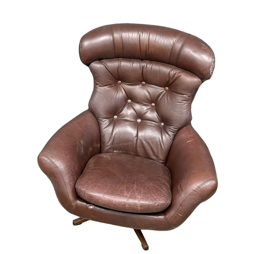 806 - A Swedish Mid Century Gungan Slatte leather swivel chair on faux rosewood base.1