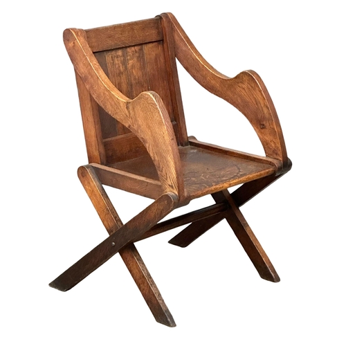 881 - A late 19th century Glastonbury oak armchair. Circa 1890-1900. 1