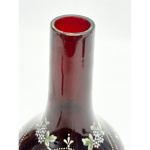 68 - A late 19th century Bohemian hand painted Ruby glass bottle vase. 14x22cm