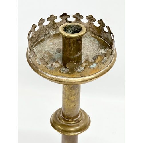 133 - A late 19th century brass church candlestick. 31cm