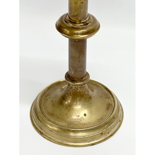 133 - A late 19th century brass church candlestick. 31cm