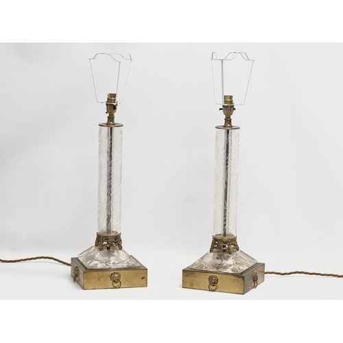 11 - A pair of large table lamps with etched glass columns on brass bases and lion mask rings. 18x18x53cm... 