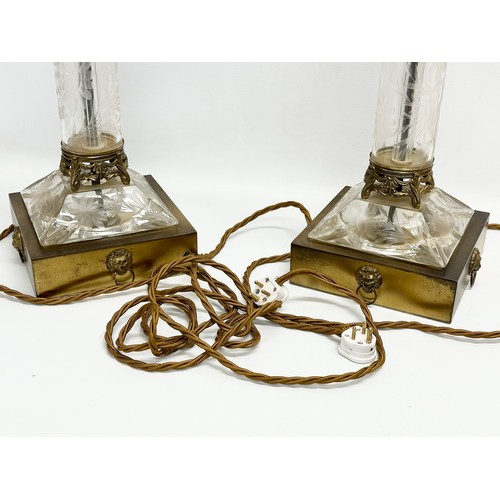 11 - A pair of large table lamps with etched glass columns on brass bases and lion mask rings. 18x18x53cm... 