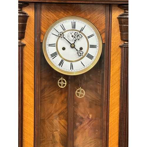 16 - A large Victorian mahogany Vienna wall clock with weights, pendulum and key. 128cm