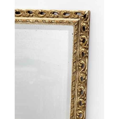 141 - A mid 20th century gilt framed bevelled mirror. 62x47cm