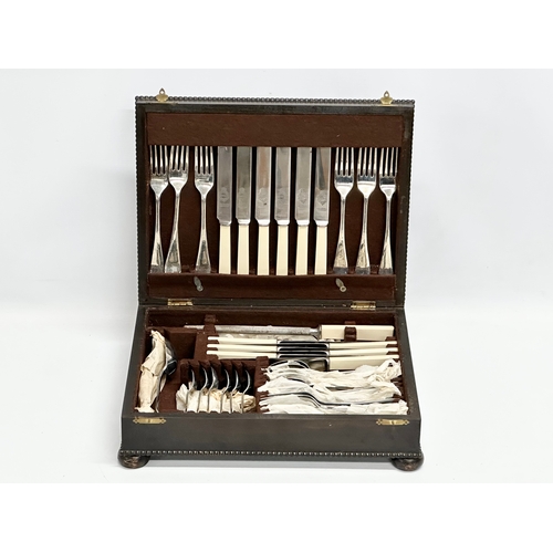 415 - An Early 20th Century oak cased canteen on cutlery. 36x29x10cm