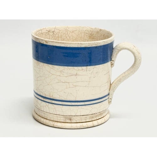 114 - A collection of Mid 19th Century Victorian Mocha Ware mugs. Including a large Edwardian blue and whi... 