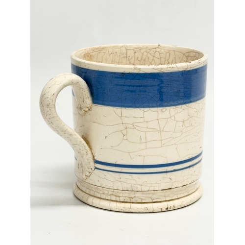 114 - A collection of Mid 19th Century Victorian Mocha Ware mugs. Including a large Edwardian blue and whi... 