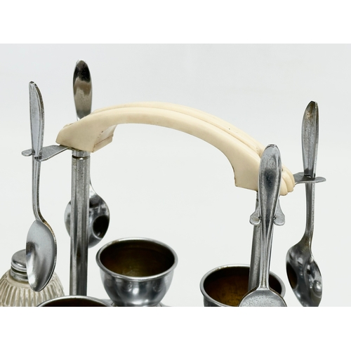 166 - A 1920’s Art Deco chrome and Bakelite breakfast set. Egg cups, salt and pepper shakers and 4 spoons ... 