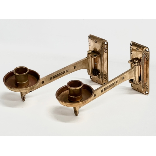 23 - A pair of Late 19th/Early 20th Century brass wall mounted candleholders. Dep Muster. 23cm