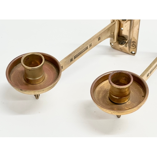 23 - A pair of Late 19th/Early 20th Century brass wall mounted candleholders. Dep Muster. 23cm