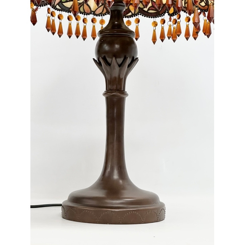 104 - A large Tiffany style table lamp with amber glass droplets. 44x70cm