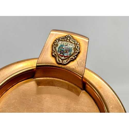 105 - A pair of South African Durban Lines ships copper and leather bound ashtrays. 11.5x13x8cm