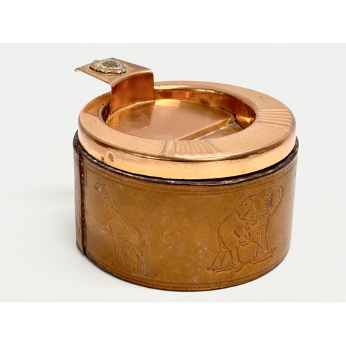 105 - A pair of South African Durban Lines ships copper and leather bound ashtrays. 11.5x13x8cm