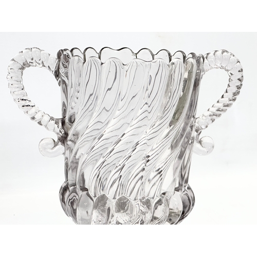 61 - A Late 19th Century Edward Moore & Co pressed glass 2 handled vase. Circa 1885-1895. 21x13x19cm