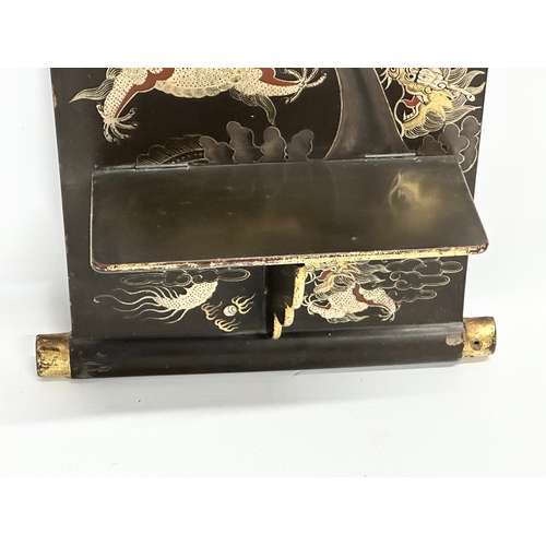 32 - An Early 20th Century Japanese hand painted lacquered wall shelf. Circa 1900-1920. 25x56cm