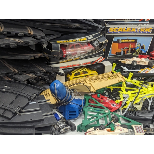 661 - A large quantity of vintage Scalextric, including tracks, cars, etc. With 2 other racecar tracks.