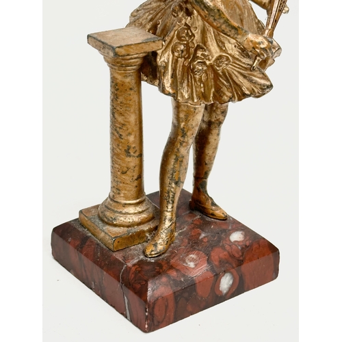 655 - A late 19th century spelter figurine on marble base. 13cm