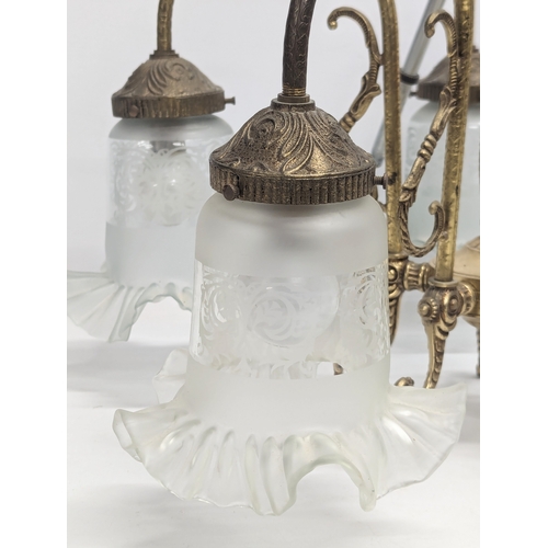 679 - A mid to late 20th century brass chandelier with etched glass shades with frilled rims. 56x66cm