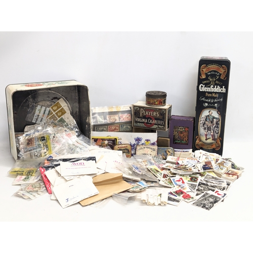 409 - A large collection of 20th Century international stamps, tins, cigarette cards, etc.