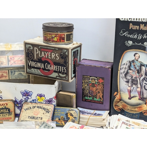 409 - A large collection of 20th Century international stamps, tins, cigarette cards, etc.