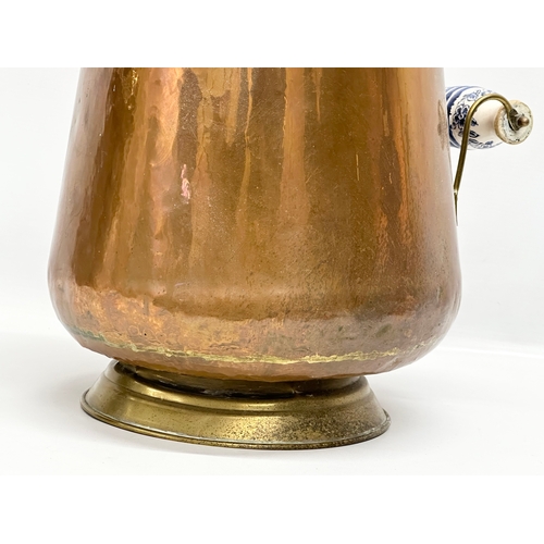 64 - A vintage copper coal scuttle with ceramic and brass handles. 46cm