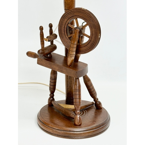 420 - A large spinning wheel table lamp. 79cm