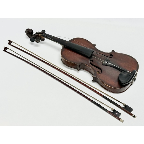 2 - An Early 20th Century violin with bows. Named and dated 1924.