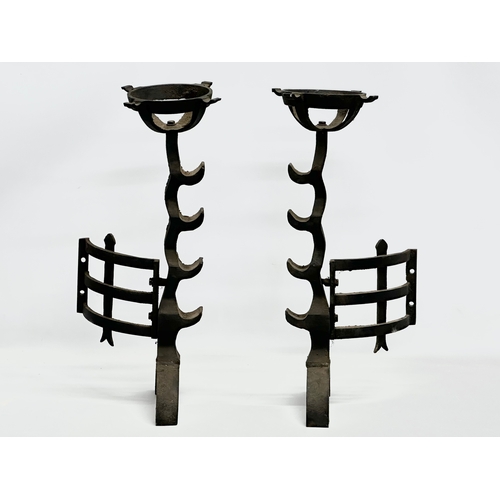 81 - A pair of large 17th Century style cast iron fire andirons. 23x56cm